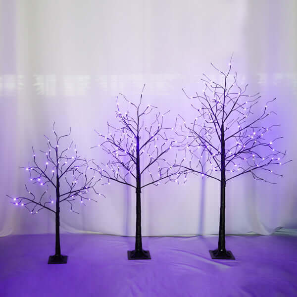 Halloween ghost trees with lights illuminated by purple lights, creating an eerie decorative effect for spooky season.