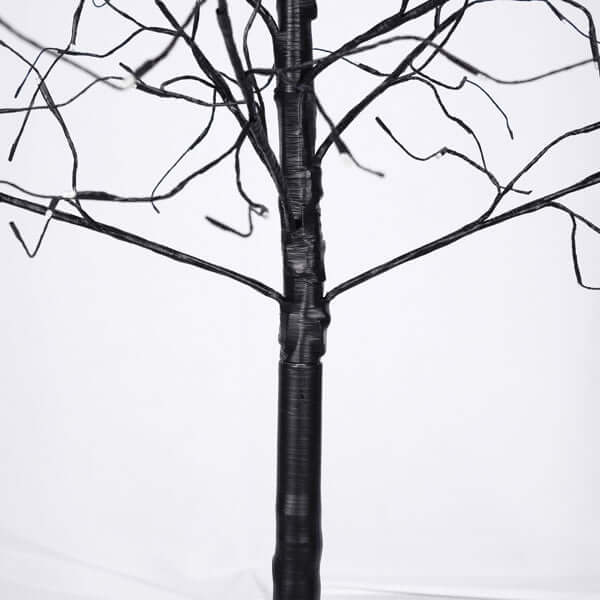 Halloween ghost trees with lights - black twisted tree branches for spooky décor centerpiece.